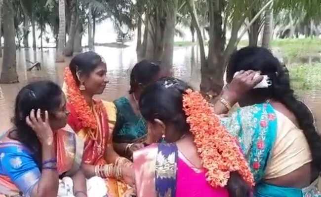 AP Bride in flood-hit village takes boat for wedding